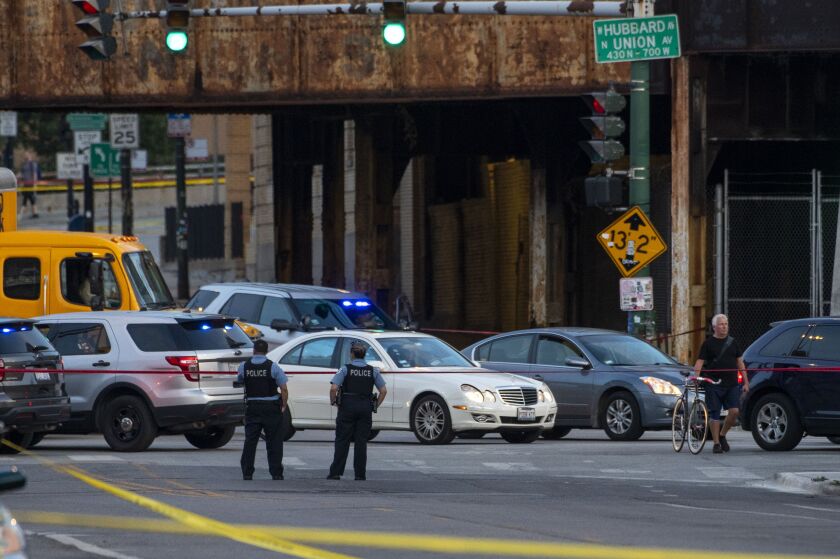 Chicago police work the scene where multiple people were shot near the Grand Avenue, Halsted Street, and Milwaukee Avenue intersection, in the West Town neighborhood, Wednesday, Sept. 29, 2021.
