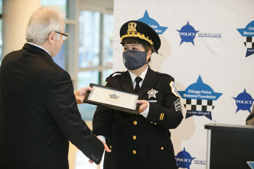 Salgado said the incident was “the scariest night of her life.” Angela Salgado receives her award at the Chicago Patrolmen’s Federal Credit Union in West Loop, Tuesday morning, Oct. 12, 2021.