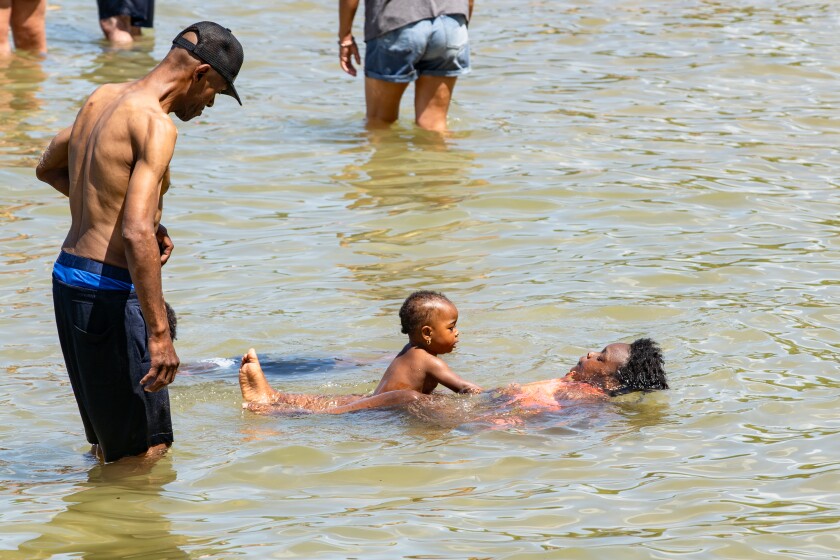 People wade in the water near Ohio Street Beach at 600 N. Lake Shore Dr., on Sunday, June 22, 2025. | Zubaer Khan/Sun-Times