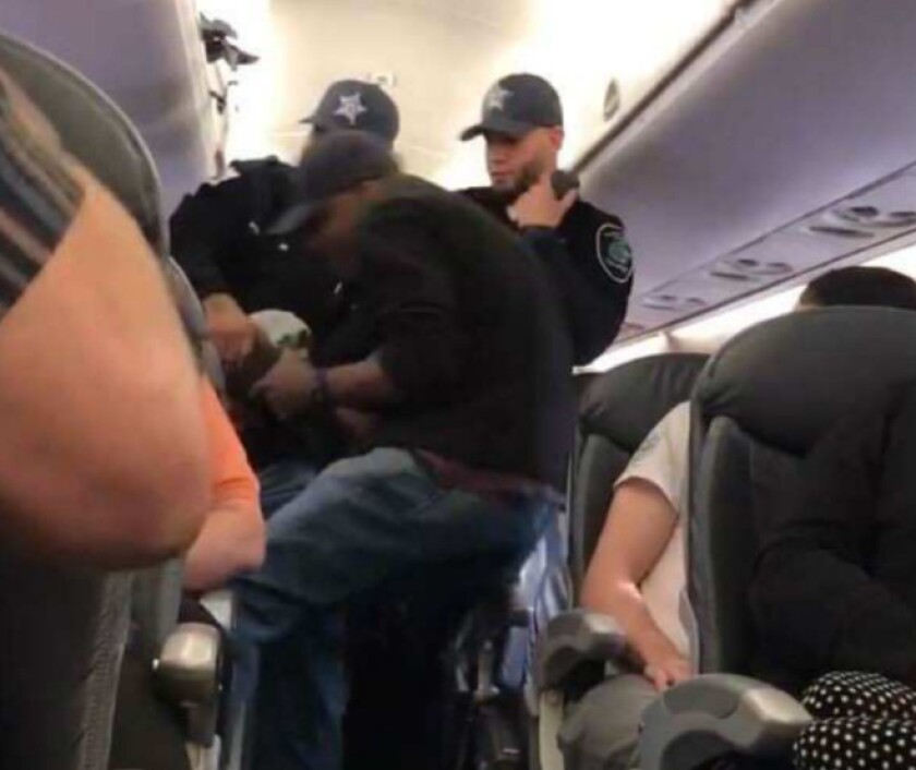 Three Chicago Department of Aviation security officers remove Dr. David Dao from United Airlines Flight 3411 on April 9, 2017.
