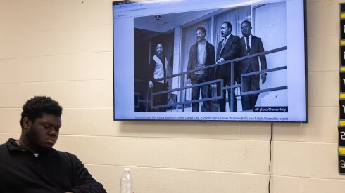 Teacher Erik Young shows the iconic photo of the Rev. Jesse Jackson with Dr. Martin Luther King in Memphis soon before King was assassinated during a lesson about about the Rev. Jackson at King College Prep.