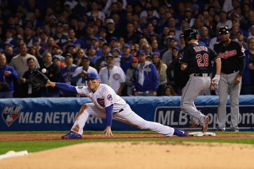 <em>Anthony Rizzo can’t catch Kris Bryant’s throw as Corey Kluber reaches first base for a single. Bryant was charged with an error, allowing the Indians’s second run to score. (Getty Images)</em>