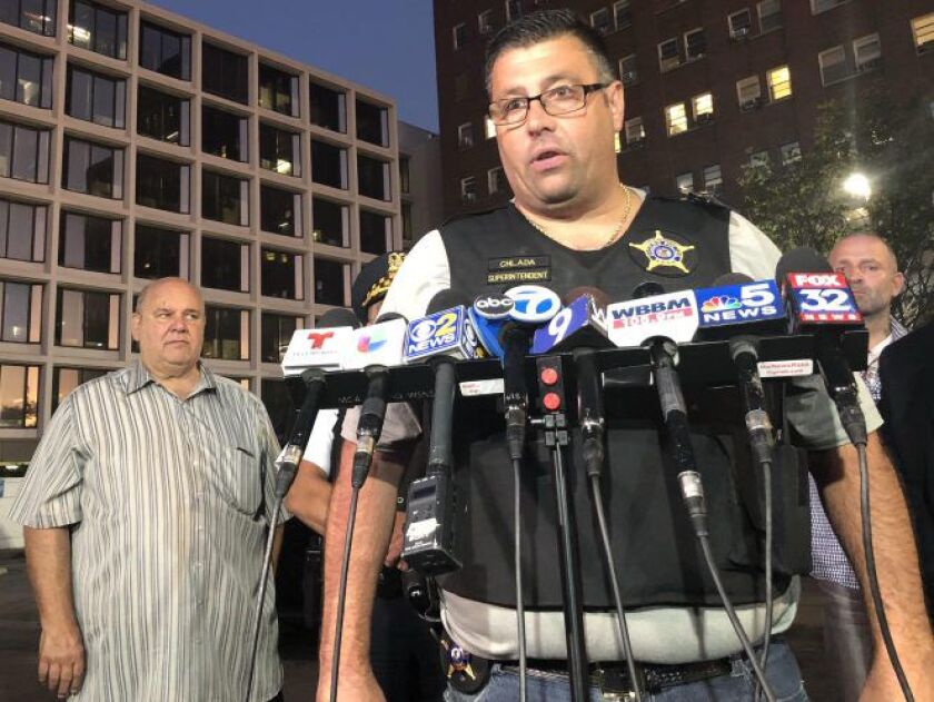 Cicero Police Supt. Jerry Chlada Jr. speaks outside Mount Sinai Hospital on Thursday night alongside Cicero Town President Larry Dominick (left). | Mitchell Armentrout/Sun-Times