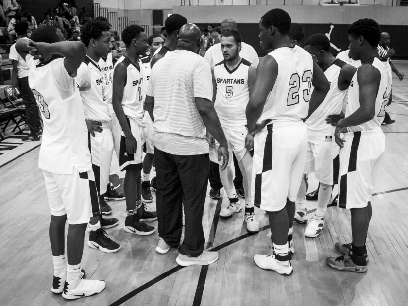 Coach Lou Adams talks to his players during a timeout against Westinghouse College Prep at Orr Academy High School, Jan. 11, 2017.