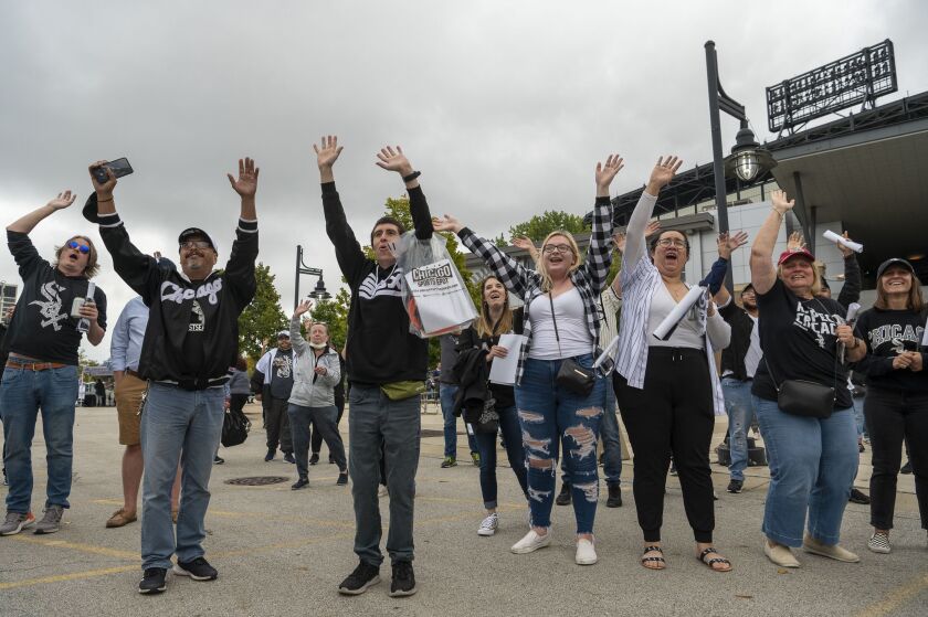 Chicago White Sox fans cheer as Sox staff throw T-shirts at them during the Change the Game Rally in the parking lot at Guaranteed Rate Field on Monday, Oct. 4, 2021.