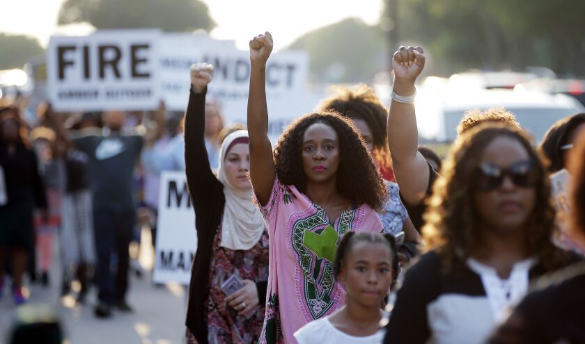 Demonstrators march around AT&T Stadium ahead of an NFL football game between the Dallas Cowboys and the New York Giants in protest of the recent killings of two black men by police, in Arlington, Texas, Sunday, Sept. 16, 2018. Botham Jean and O’Shae