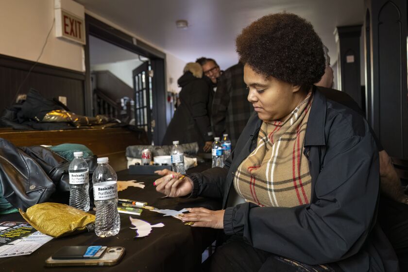 Tishjá Harvey writes down goals, ideas, and aspirations on pieces of paper in the shape of birds.