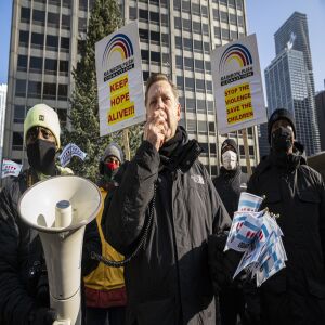 The Rev. Michael Pfleger speaks to the crowd protesting Chicago violence.