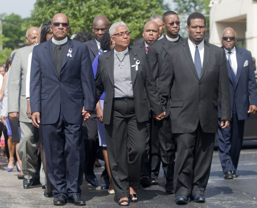 Rev. James Miller (left) and Rev. Lana Parks Miller (center) lead a prayer walk remembering Sandra Bland on Sunday, July 19, 2015, in Lisle, Illinois. | Mike Krebs/Daily Herald via AP