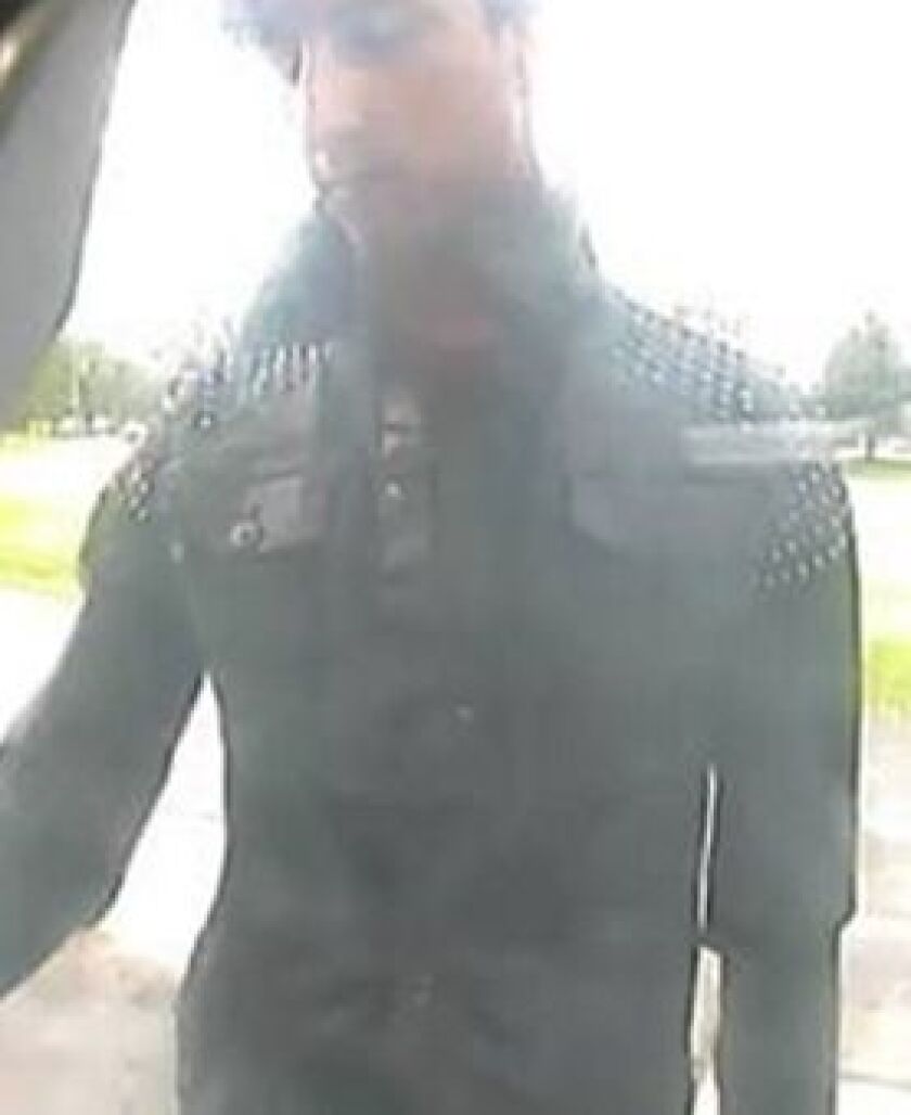 Surveillance photo of a person suspected of installing two skimmers on bank ATMs Sunday morning in Aurora. | Aurora police
