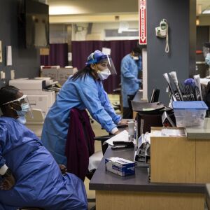 Nurse practitioner Capri Reese talks to a Chicago Fire Department EMT in the Emergency Department at Roseland Community Hospital, Tuesday afternoon, April 28, 2020. During Reese’s 12-hour shift Tuesday, she responded to five code blues and three patients suffering from COVID-19 died.
