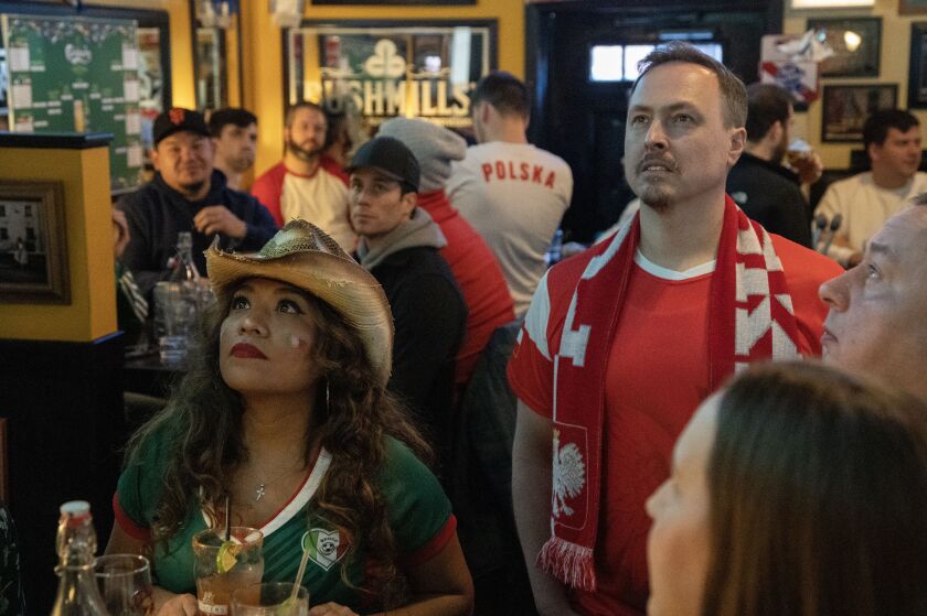Married couple Greg and Oralia Niewiadomski watch the Mexico vs. Poland World Cup game at A.J. Hudsons Public House at 3801 N Ashland Ave. Tuesday, November 22, 2022.