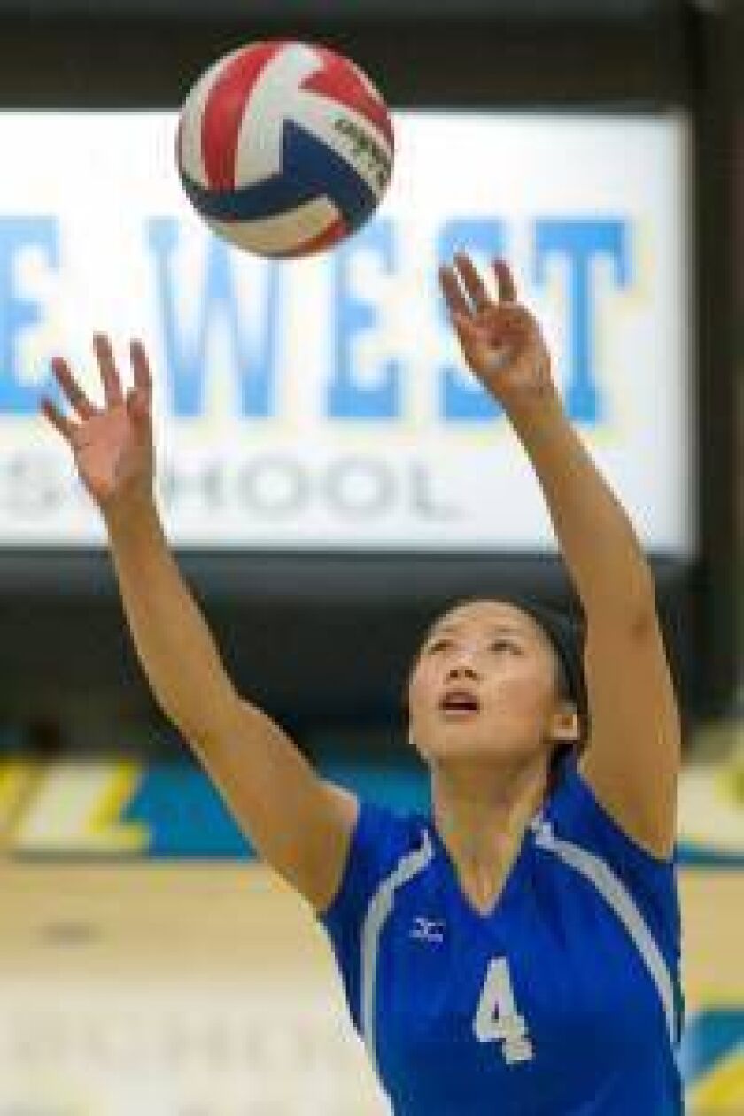 Maine East’s Sarah Hua-Pham (4) sets the ball Monday against Maine West. | Nic Summers/for Sun-Times Media