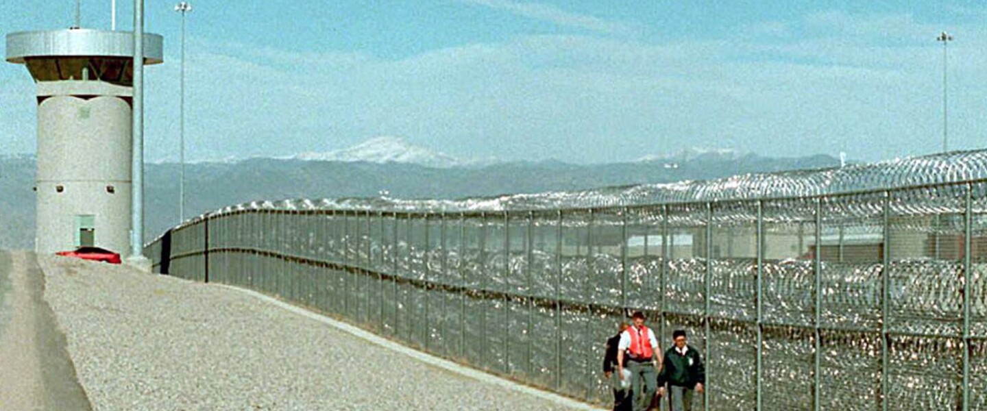 Guards walk along the fence at the super-maximum-security federal prison in Florence, Colorado, where Larry Hoover is being held. 