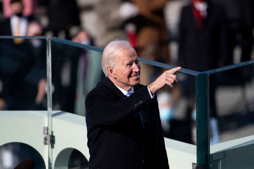 President Joe Biden points to guests attending his inauguration on the West Front of the US Capitol on Wednesday.