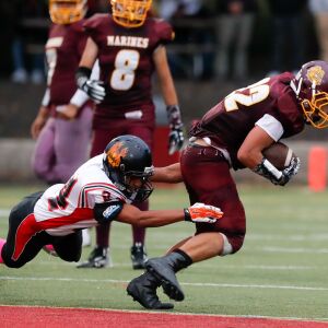 Phoenix’s Rafel Soto (24) takes down Marine’s Daniel Kettleson (22).