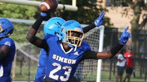 Simeon’s Jaykwon Armour (23) celebrates after he intercepts a pass in the last minute of the game to seal the Wolverines 35-31 win over Bolingbrook.