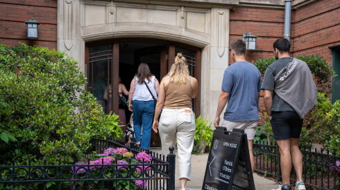 Prospective homebuyers and their agents walk into a Lake View condo building for an open house.