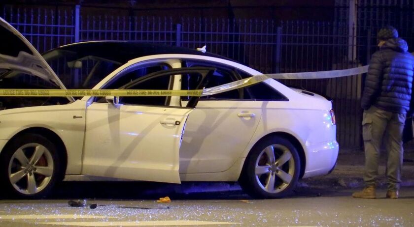 A Chicago Detective looks over a car that crashed into a pole on the 12900 block of Halsted after the driver was shot. The driver was later pronounced. | Justin Jackson / Sun-Times
