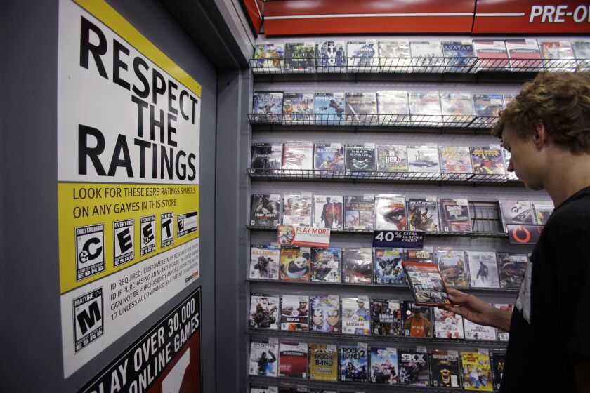 Grand Theft Auto and other video games — and warnings about the content of those games — prominently displayed at a GameStop store.