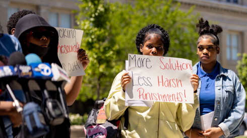 A Hyde Park Academy student holds a protest sign.