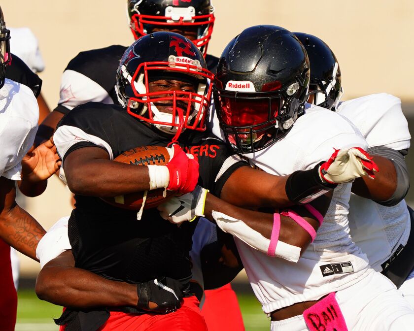 Raby’s Kierre Turner (1) is brought down by Clark’s Jassani Freeman (11).
