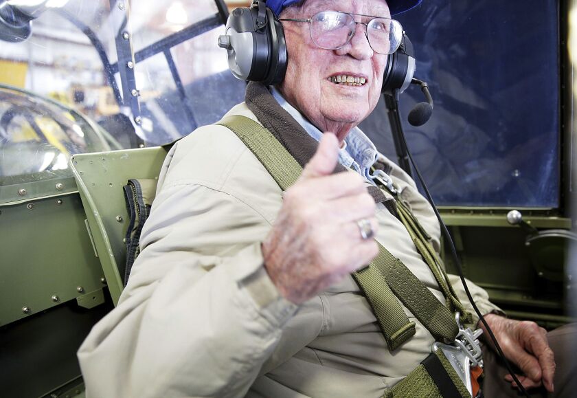 Jim Lair is strapped into Brad Deckert’s TBM Avenger at the Illinois Valley Regional Airport in Peru, Ill. During WWII, Lair, 90, usually rode below as the radio operator on the Avenger, which held three crew members. But this time, he opted for the gunn