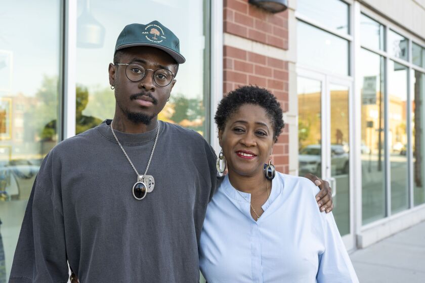 Makafui Searcy, owner of Fourtunehouse Art Center, with his mother Sarah Kuenyefu, who owns Sarah Kuenyefu Collection, outside their businesses, which are next door to each other at 4410 S. Cottage Grove Ave. and and 4412 S. Cottage Grove Ave. in Bronzeville.