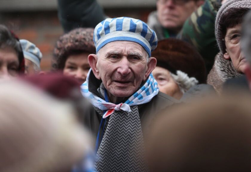 <small><strong>Members of an association of Auschwitz concentration camp survivors arrive to lay wreaths at the execution wall at the former Auschwitz I concentration camp on January 27, 2015 in Oswiecim, Poland. | Sean Gallup / Getty Images</strong></sma