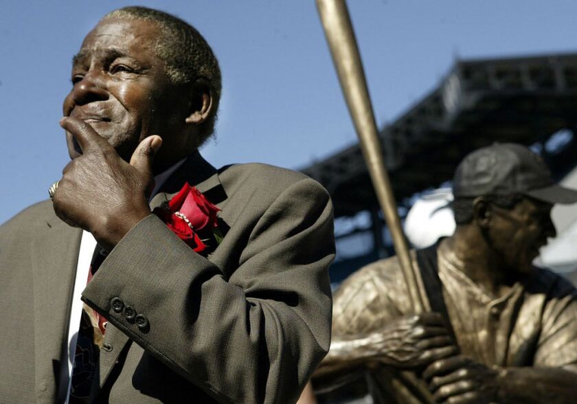 Minnie Minoso participates in the sculpture’s unveiling before throwing out the ceremonial first fitch at U.S. Cellular Field before the game between the White Sox and Detroit Tigers on Sept. 19, 2004. The Chicago White Sox unveiled a life-sized sculpture