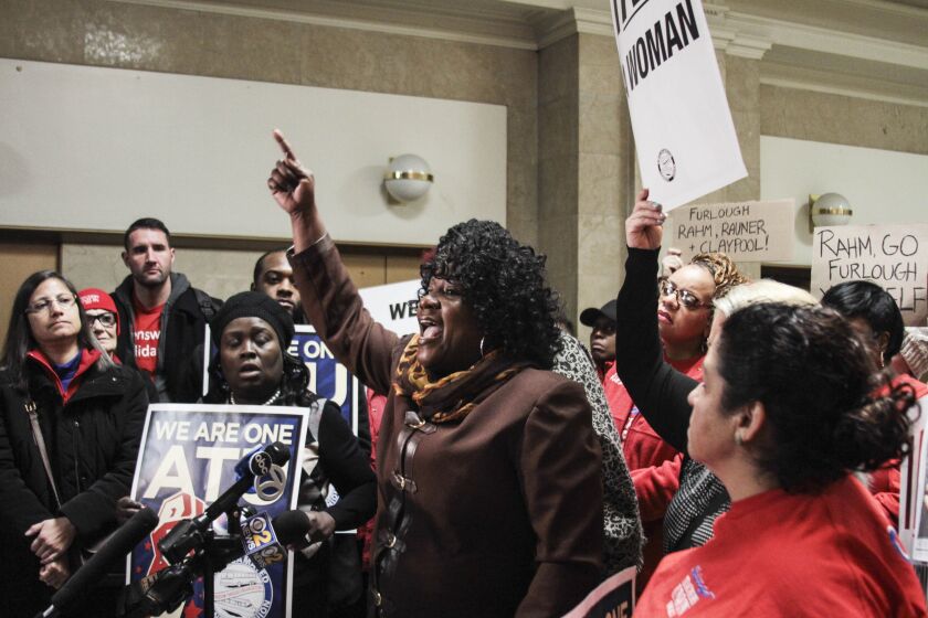 Amalgamated Transit Union employee Deborah Lane addresses protesters outside Mayor Rahm Emanuel’s office Friday. | Maria Cardona/ Sun-Times