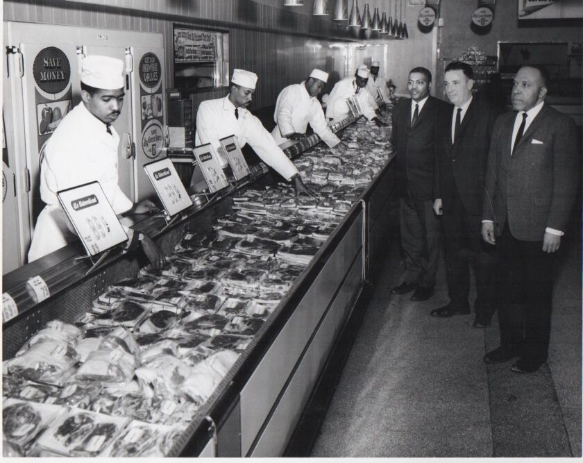 Robert H. Vaughn, (first man in dark suit on left, with mustache) who rose to be an international vice president of the United Food and Commercial Workers, during a visit with union meat-cutters. | Provided photo