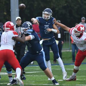 Marist’s Triston Schultz (45) pushes Nazareth’s J.J McCarthy (2). Worsom Robinson/For the Sun-Times.