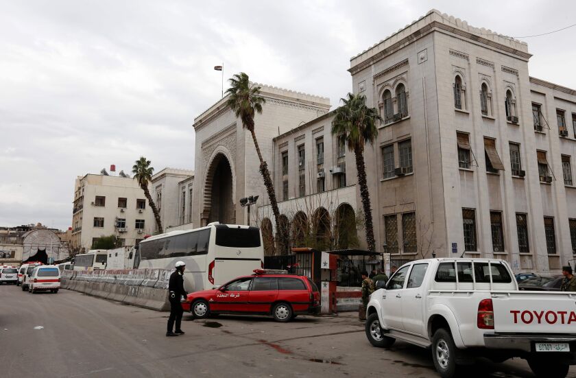 Syrian security forces cordon off the area following a reported suicide bombing at the old palace of justice building in Damascus on Wednesday. | Louai Beshara/AFP/Getty Images