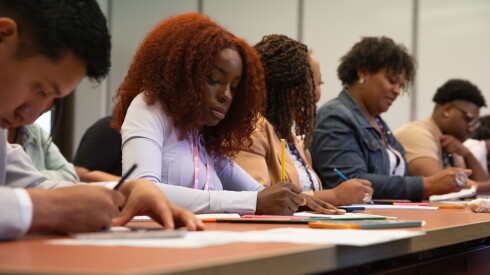 Rai-Elle Ingram works on her superhero "Ultra Rain" during Edgardo Miranda-Rodriguez's workshop at the Obama Presidential Center.