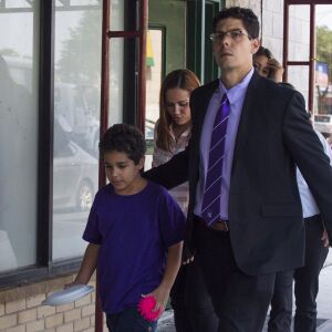 Lidia Souza, her nine-year-old son Diogo and their attorneys walk out of the office of Heartland Alliance in Chicago. | Pat Nabong/For the Sun-Times