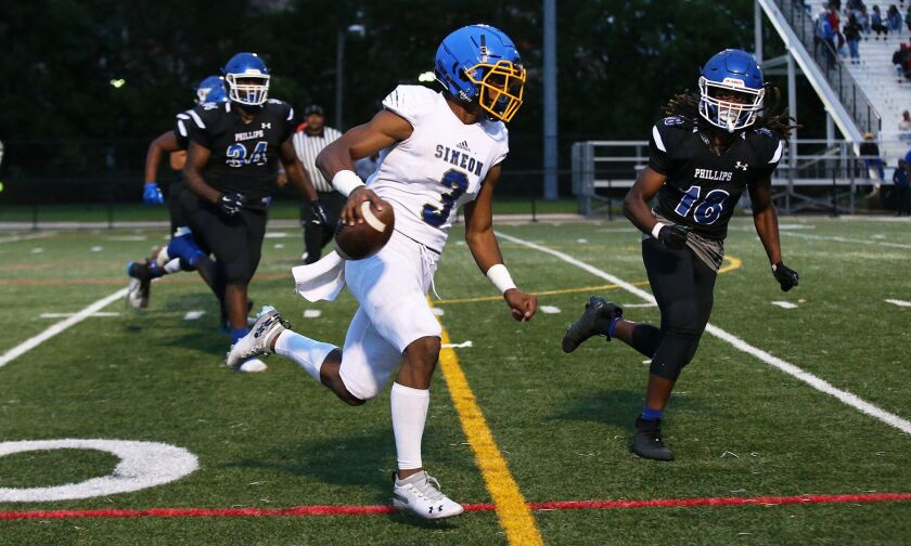 Simeon’s Alante Brown (3) scrambles for a first down. Allen Cunningham/For the Sun-Times.