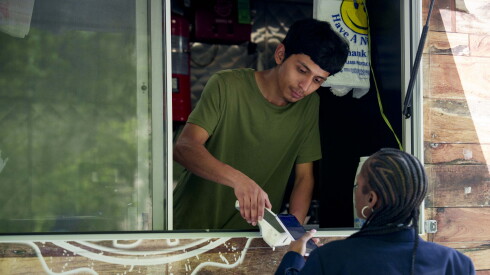 One of the food truck employees at Caseras Sabor Real takes a customer’s order in the Loop.