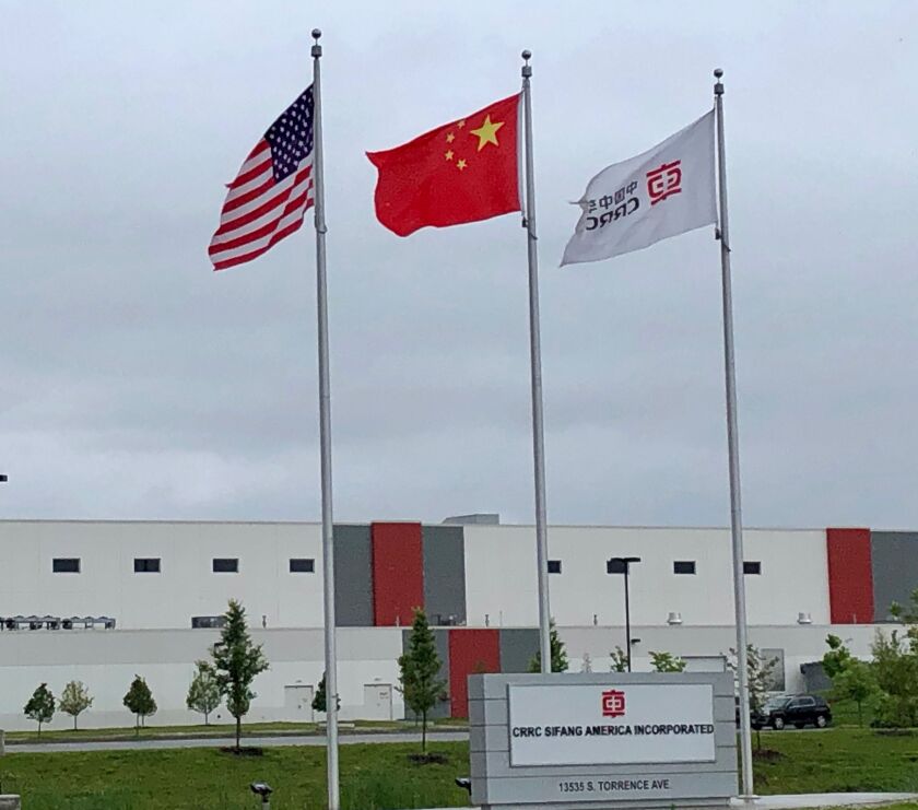 Three flags fly in front of the CRRC Sifang American plant on the South Side of Chicago.