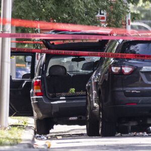 Officers investigate at the scene where Klevontaye White was fatally shot during a standoff with police Friday morning in the 100 block of South Kilpatrick Avenue.