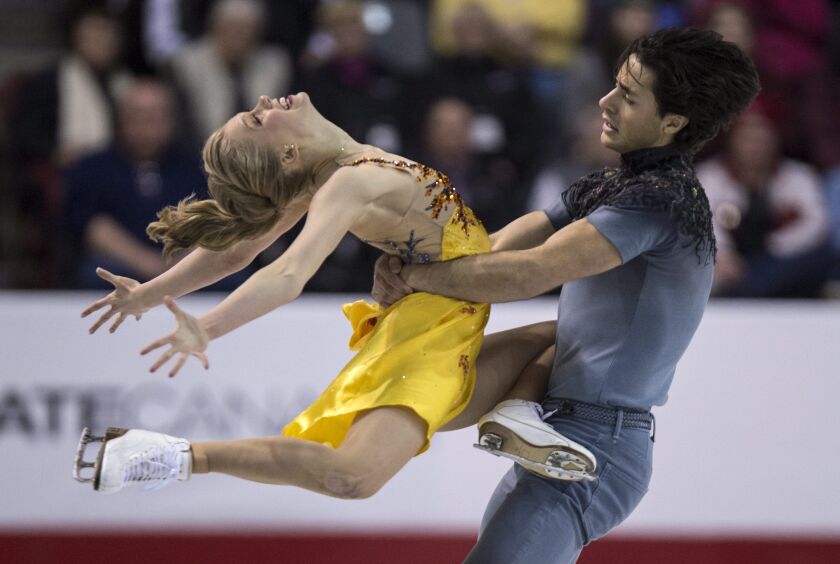 Kaitlyn Weaver and Andrew Poje perform their free dance to win the gold medal in the ice dance competition at the Canadian Figure Skating Championships in Kingston, Ontario. (AP Photo/The Canadian Press, Paul Chiasson)