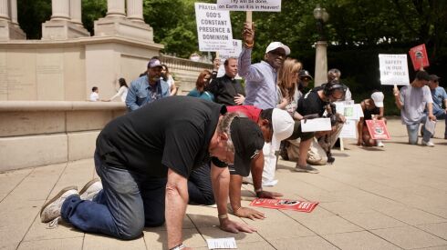 A group of church leaders and others gathered to for a prayer walk down Michigan Avenue Saturday. It took place following a deadly month of gun violence in Chicago and ahead of a historically violent holiday weekend.
