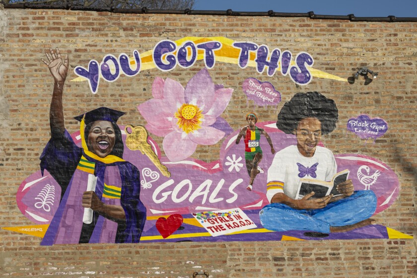 A mural by Pugs Atomz is on the side of Gyrls in the H.O.O.D. Foundation in Grand Crossing.