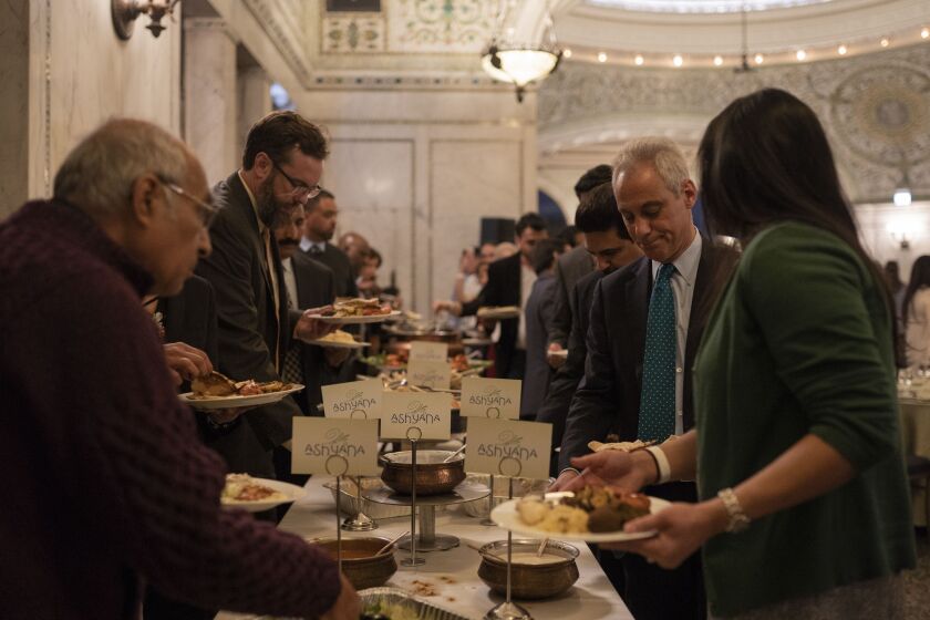 Mayor Rahm Emanuel helps himself to food during the annual iftar meal at the Chicago Cultural Center on May 7, 2019. | Pat Nabong/For The Sun-Times.