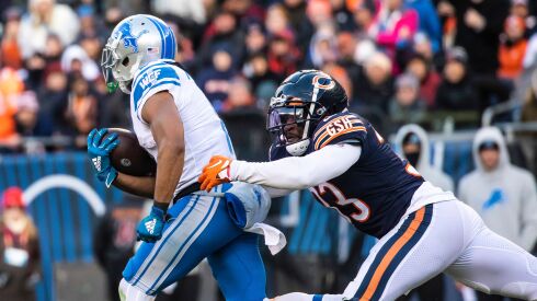 Chicago Bears cornerback Jaylon Johnson tackles Detroit Lions wide receiver Kalif Raymond during the fourth quarter at Soldier Field on Sunday.