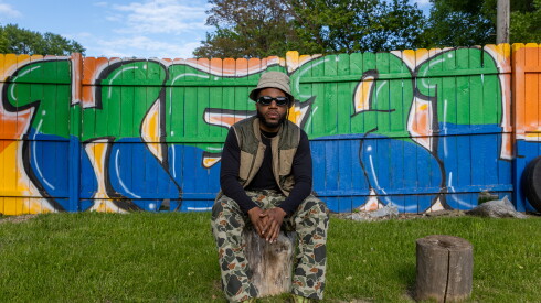 Rapper Heavy Crownz stands in the Imagine If Peace Garden in Englewood.