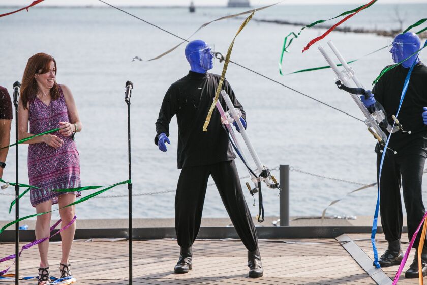 The Blue Man Group made a surprise appearance Tuesday, shooting ribbons all over the Lake Stage and into the crowd.