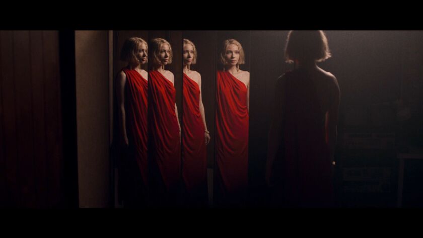 Narrator_played_by_Tavi_Gevinsen_in_red_dress.jpg