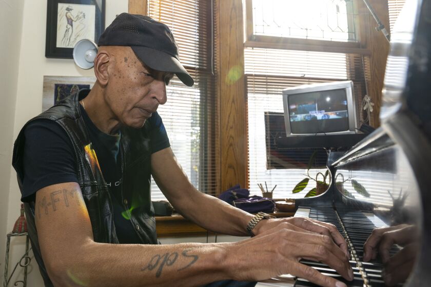 Bradley Parker-Sparrow plays on his piano in his Lake View home.