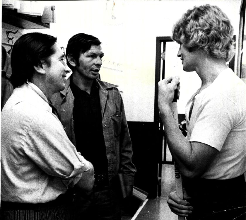 Then-Chicago Blackhawks star Keith Magnuson (right) in September 1974 with Dr. Randall McNally (left) and teammate Stan Mikita. The Hawks had began workouts at the old Chicago Stadium, and Dr. McNally was on hand to give physicals.